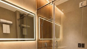 A modern bathroom with a glass-enclosed shower, a toilet, and a vanity with a mirror. - DOM HOTEL DALAT (Lam Vien - Da Lat)