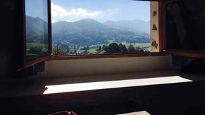 A room with a large window overlooking a mountainous landscape. - Large family home in Bagnères-de-Bigorre (Bagnères-de-Bigorre)