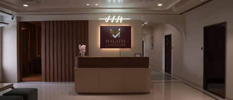 A reception area with a sign for 'MALATIYA LANDMARK' and a modern reception desk.