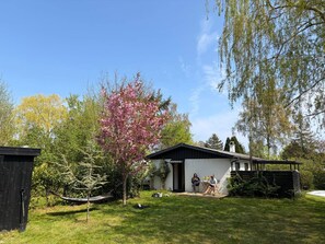A residential property with a white house, a black roof, and a garden. - 5 Star Holiday Home in Stubbekobing (Stubbekobing)