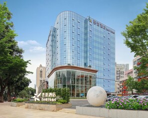 A modern hotel building with a glass facade and a prominent entrance. - Eeril Hotel Futian Port  (Shenzhen)