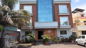 A two-story building with a sign reading 'SIDDHIVINAYAK EXECUTIVE LODGING.'