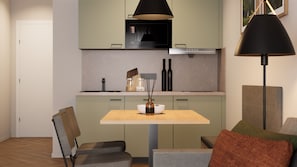 A modern kitchen with a dining area, including a table, chairs, and a pendant light. - Apartment 4 Northwest - small balcony (Bad Reichenhall)