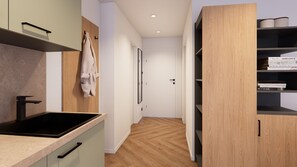 A modern kitchen with a black sink, wooden cabinets, and a hallway leading to a door. - Apartment 3 North East - no balcony (Bad Reichenhall)