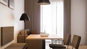 A modern hotel room with a dining area, a sofa, and a large window with curtains. - Apartment 1 South East - Balcony (Bad Reichenhall)