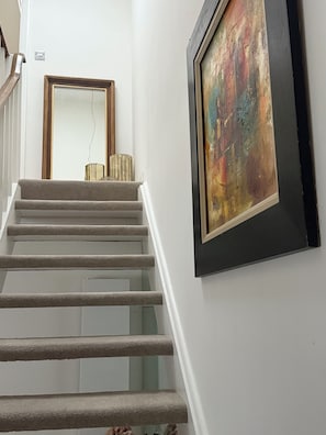 Eine Treppe mit Handlauf und einem an der Wand befestigten Bilderrahmen.