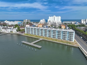 A waterfront hotel with a modern design, featuring multiple balconies and a marina. - Endless Bay Views | Ground-Floor Ocean City Escape (Ocean City)
