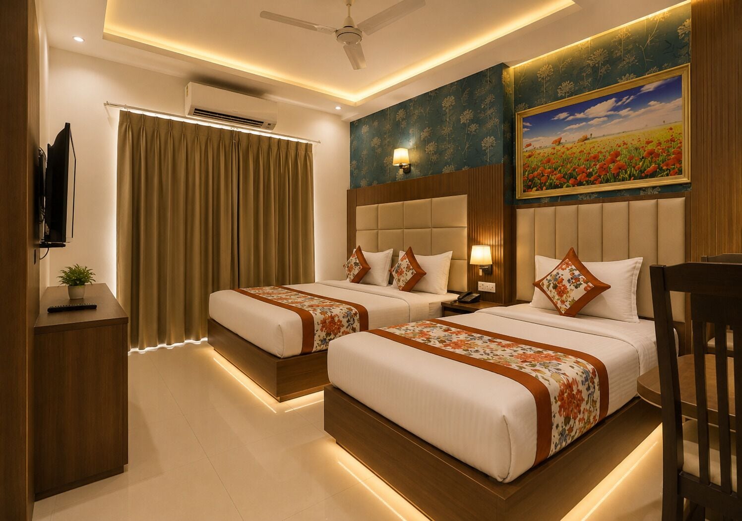Habitación de hotel con dos camas, televisión, equipo de aire acondicionado, escritorio con planta y un cuadro en la pared.