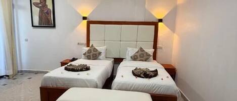 A bedroom with a double bed, a single bed, and a daybed.