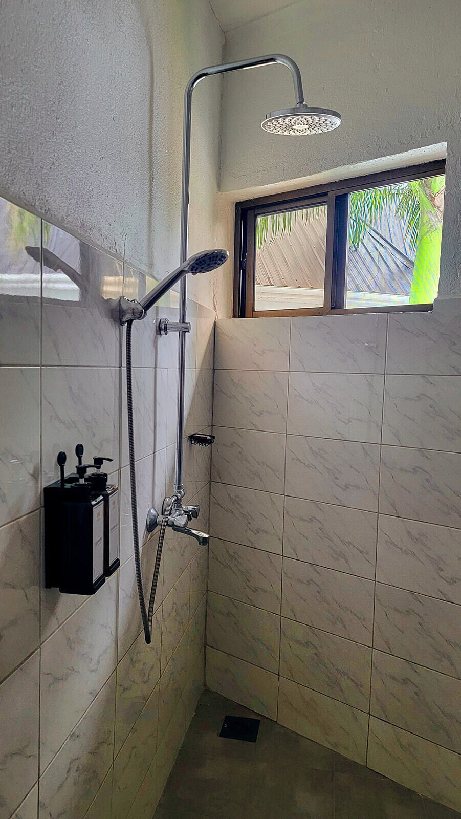 Ducha con cabezal de ducha de mano y grifo empotrado.