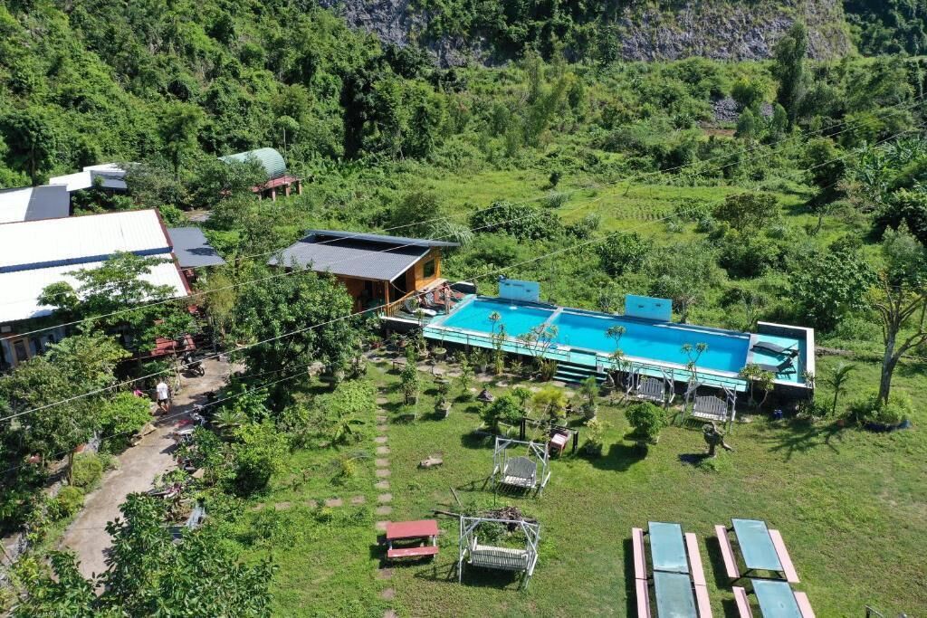 A residential property with a swimming pool, a covered patio, and a garden.