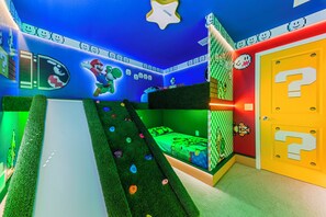 A room with a bed, a slide, and a door with a question mark. - Magical 5BR Disney Getaway with Private Pool, Themed Rooms & Resort Amenities (Davenport)
