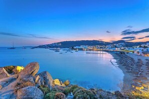 A coastal town with a beach, boats, and a pier. - Beachfront Mykon Villa – Your Relaxing Getaway in Platys Gialos (mykonos)