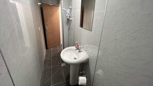 A bathroom with a white sink, a mirror, and a shower. - Harbour View Apt, Oceana (East Riding of Yorkshire)