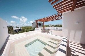 A rooftop terrace with a hot tub, outdoor seating, and a pergola. - PH Tucán: Private Terrace and Ocean View rooftop (Puerto Morelos)
