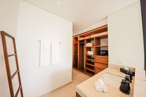 A hotel room with a wooden closet, a bathroom with a sink and towel rack, and a ladder against the wall. - PH Tucán: Private Terrace and Ocean View rooftop (Puerto Morelos)