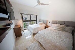 Bedroom with two single beds TV and ceiling fan