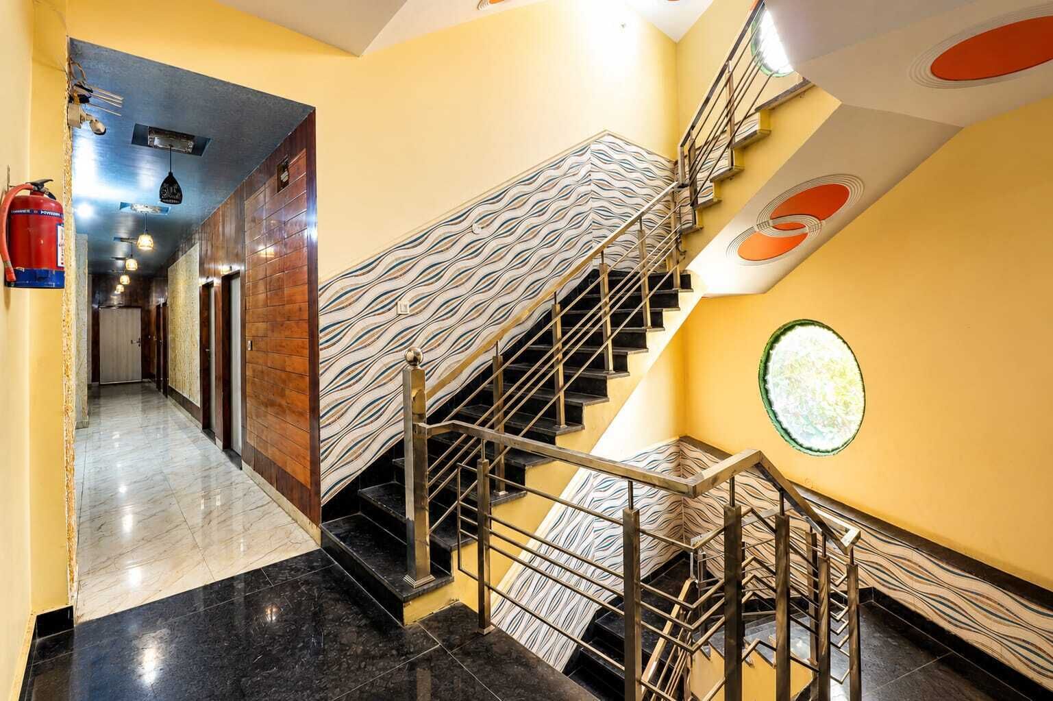A staircase with a unique wavy pattern on the steps and walls, leading to an upper floor.