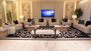 A modern living room with two sofas, a coffee table, and a TV. - Darina Serviced Apartments2 (Riyadh)