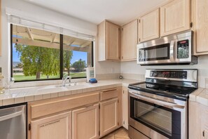 A modern kitchen with a built-in oven, microwave, and stainless steel appliances. - Palm Desert Resort Condo | Preston Trail | Near Indian Wells Tennis Garden & Golf (Palm Desert)
