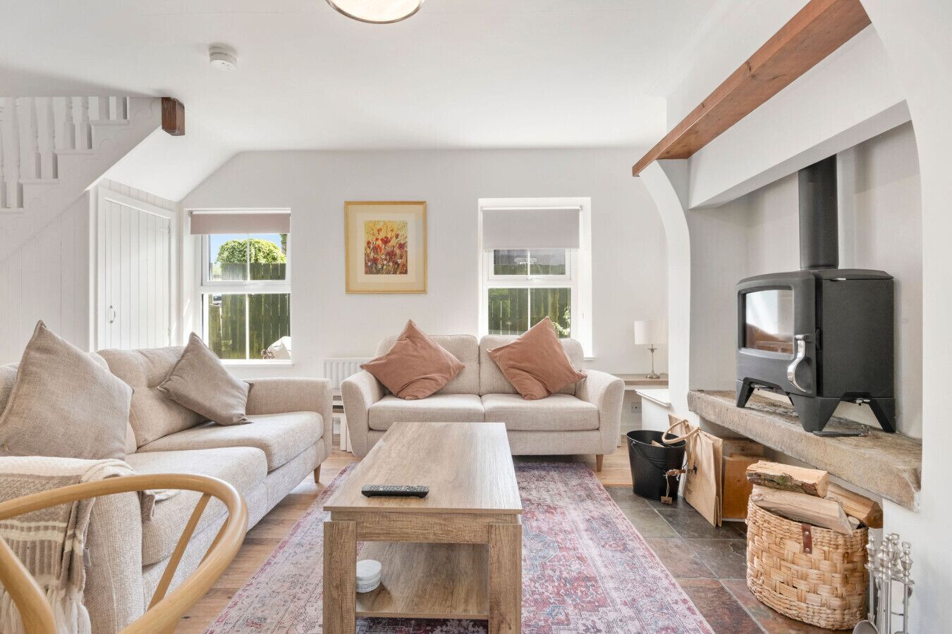 A cozy living room with a sofa, a coffee table, and a fireplace.