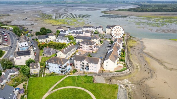 A residential area with houses, a road, and a river. - The Lookout · Dundrum Bay · Balcony with Bay Views (Dundrum)