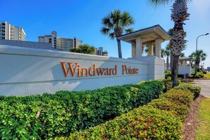 A sign for Windward Pointe with a clear view of the surrounding greenery and buildings. - Windward Pointe 1204 by Liquid Life (Orange Beach)