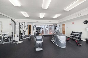 A gym with various exercise equipment, including treadmills, a stationary bike, and weight machines. - San Carlos 1409 by Liquid Life (Gulf Shores)