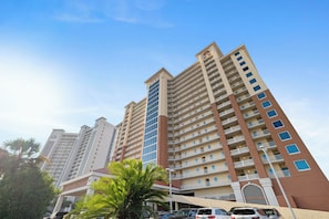 A high-rise residential building with multiple balconies and a clear sky. - San Carlos 1409 by Liquid Life (Gulf Shores)