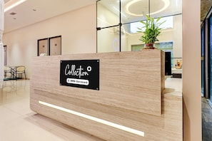 A reception desk with a sign indicating it is serviced by YOYO.