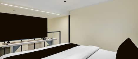 A modern hotel room with a bed, a desk, and a television.