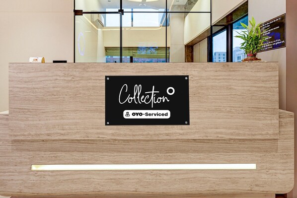 A reception desk with a sign that reads 'Collection' and 'OYO-Served'.