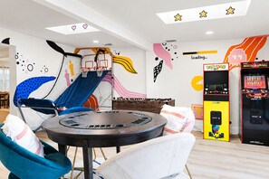 A children's play area with a slide, a foosball table, and arcade games. - Resort-style 5BR/3BA home, 8 min to Anna Maria Island. Private heated pool, splash pad, home theater, arcade, pickleball court, sauna & hot tub — sleeps 18 with a boat-themed bunk room kids love. Everything your group needs, right at home. (Bradenton)
