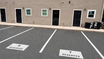 A parking lot with two marked spaces, labeled 6 and 7, reserved for specific purposes.