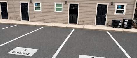 A parking lot with two marked spaces, labeled 6 and 7, reserved for specific purposes.
