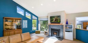 A modern living room with a fireplace, a television, and a blue wall. - Mare Vista (TOT # 2194): 2  BR, 2  BA House in The Sea Ranch, Sleeps 4 (The Sea Ranch)