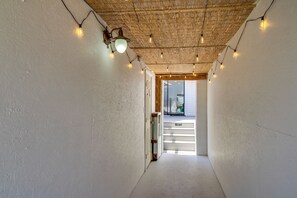 A narrow hallway with a wooden ceiling and string lights. - Walk to Beach! Prime Okaloosa Island Townhome (Fort Walton Beach)