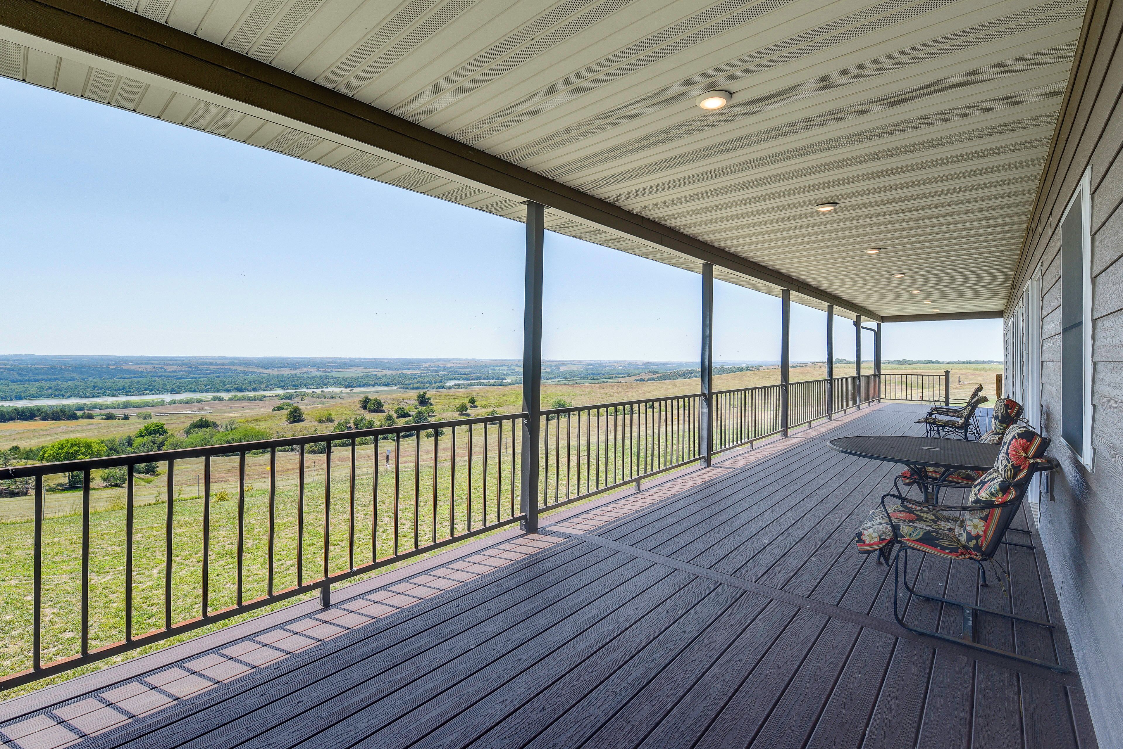 A covered outdoor area with a view of a landscape.