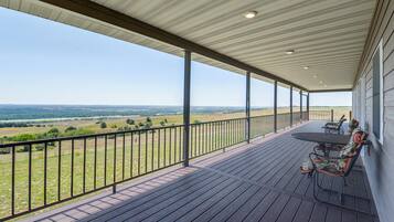 A covered outdoor area with a view of a landscape.