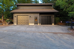A two-story building with a garage and a driveway.