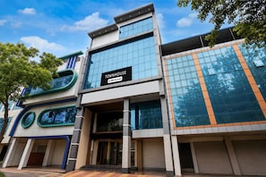 A modern townhouse with a sign indicating it is serviced by OYO.