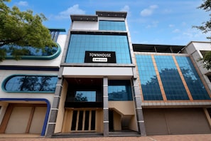 A modern building with a sign reading 'TOWNHOUSE OYO-Serviced'.