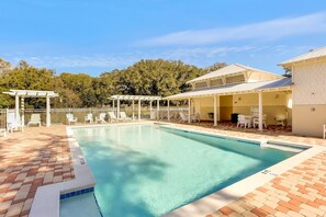 A swimming pool with lounge chairs and a covered seating area. - Summerwoods 1504 2 Bedroom Condo (Fernandina Beach)