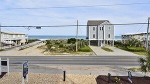 A beachfront property with a two-story house, a paved driveway, and a beach access road. - Coastal Treasure: Steps to Beach & Pool (Murrells Inlet)