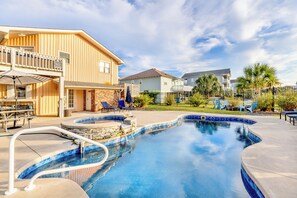 A residential area with a swimming pool, a covered patio, and a two-story house with a balcony. - Good Ol' Days: Private Pool, Hot Tub & Steps to the Beach (Murrells Inlet)