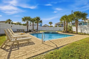 A swimming pool with lounge chairs and a wooden deck. - Peachy Keen: Private Pool, Ocean Views & Steps from the Sand (Murrells Inlet)