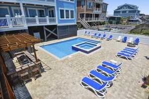 A rooftop pool area with lounge chairs and a barbecue setup. - Sea Suite: Oceanfront Retreat, Private Pool & Hot Tub (Murrells Inlet)