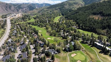 A residential area with houses, roads, and a golf course.