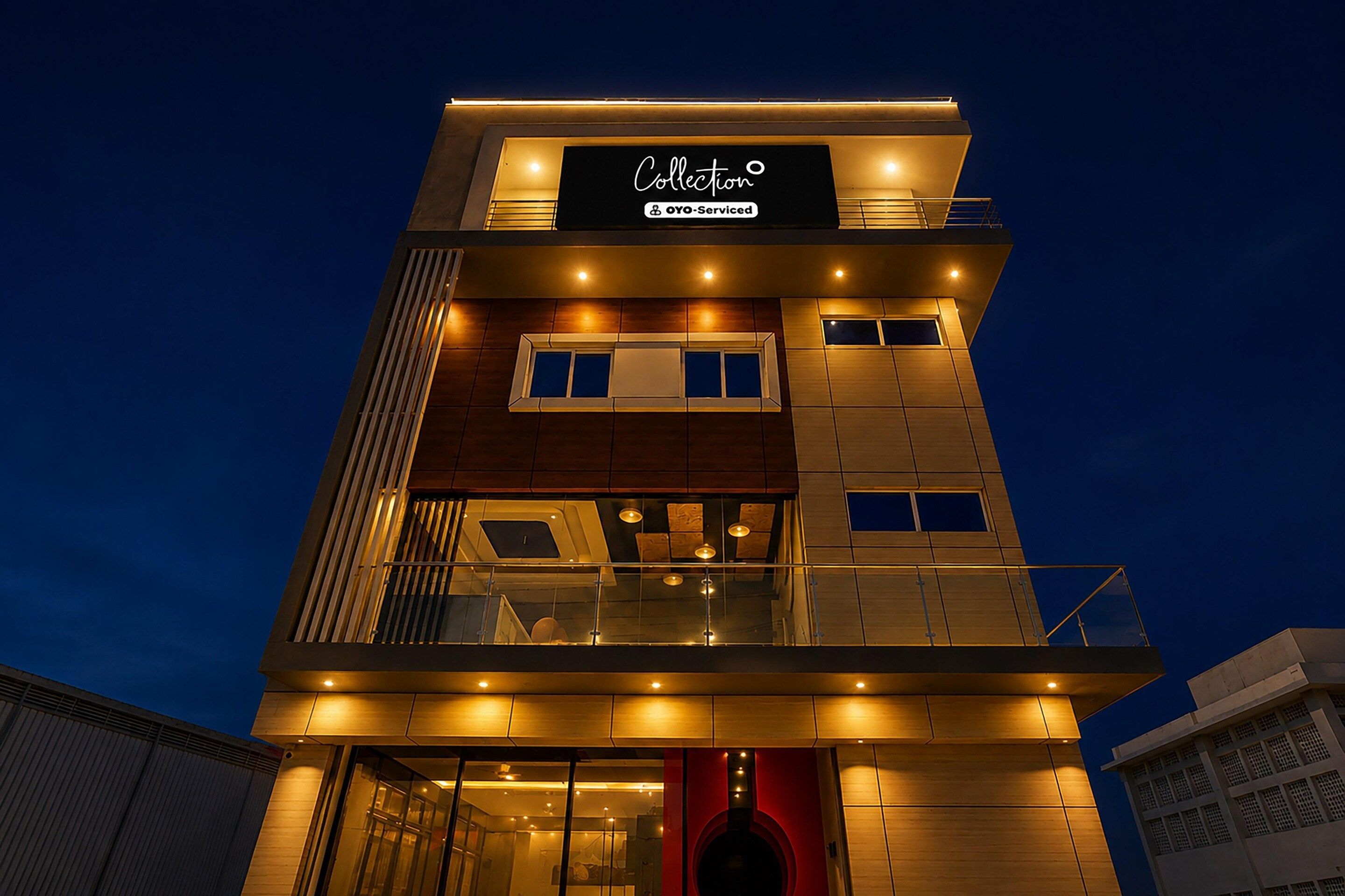 A multi-story building with a sign indicating it is serviced by OYO.