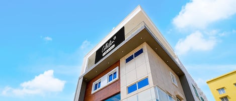 A multi-story building with a prominent sign at the top.